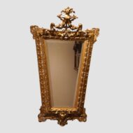 Full view of ornate antique gilt trapezoidal mirror, 130cm high and 76cm wide