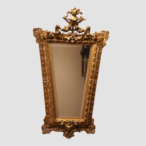 Full view of ornate antique gilt trapezoidal mirror, 130cm high and 76cm wide