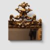Decorative antique trapezoidal mirror with richly ornamented gilt and silver-gilt frame