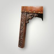 Close-up of the carved front leg showing Chippendale blind fret carving and decorative carved bracket on a Georgian mahogany Gainsborough chair.