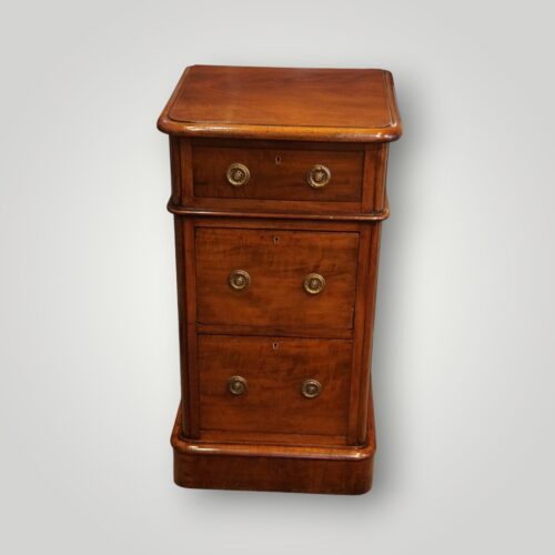 Front view of Victorian mahogany three drawer bedside chests