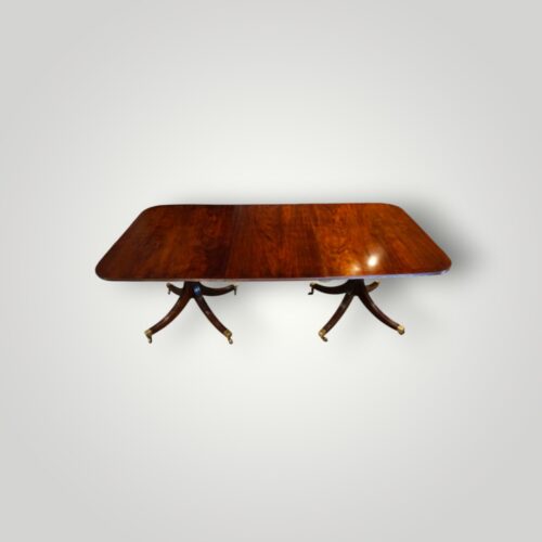 Regency style mahogany twin pillar dining table circa 1910 with removable leaf.