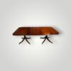 Regency style mahogany twin pillar dining table side view