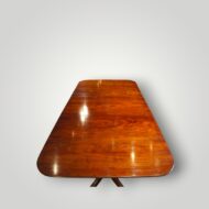 Antique Regency style twin pillar dining table in richly figured Georgian mahogany