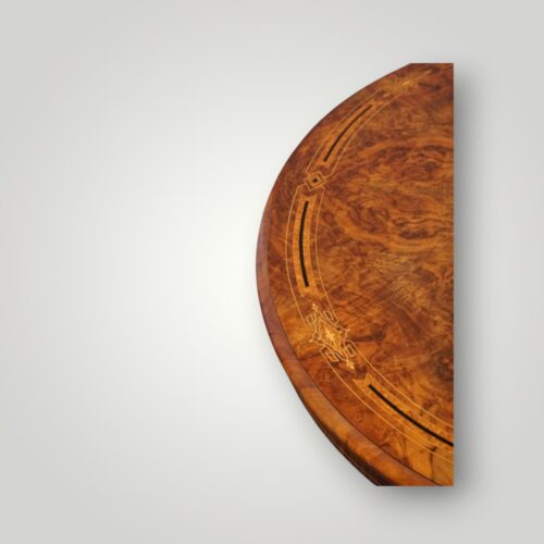 Antique inlaid walnut coffee table showing detailed oval top