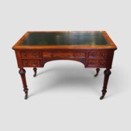 Victorian mahogany writing table by Holland & Sons with green leather writing surface and five drawers.