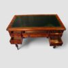 Superb Victorian antique writing desk by Holland & Sons featuring a hand-tooled green leather writing surface and mahogany construction.