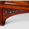 Elegant antique Holland & Sons library writing table with figured mahogany, carved details and brass castors.