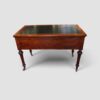 Antique Victorian mahogany partner's writing desk by Holland & Sons standing on carved turned legs with brass castors.