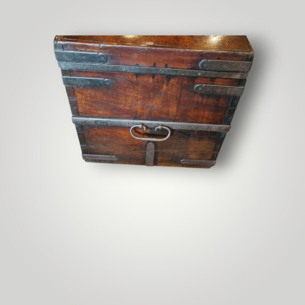 Close‑up of iron strapping on antique trunk