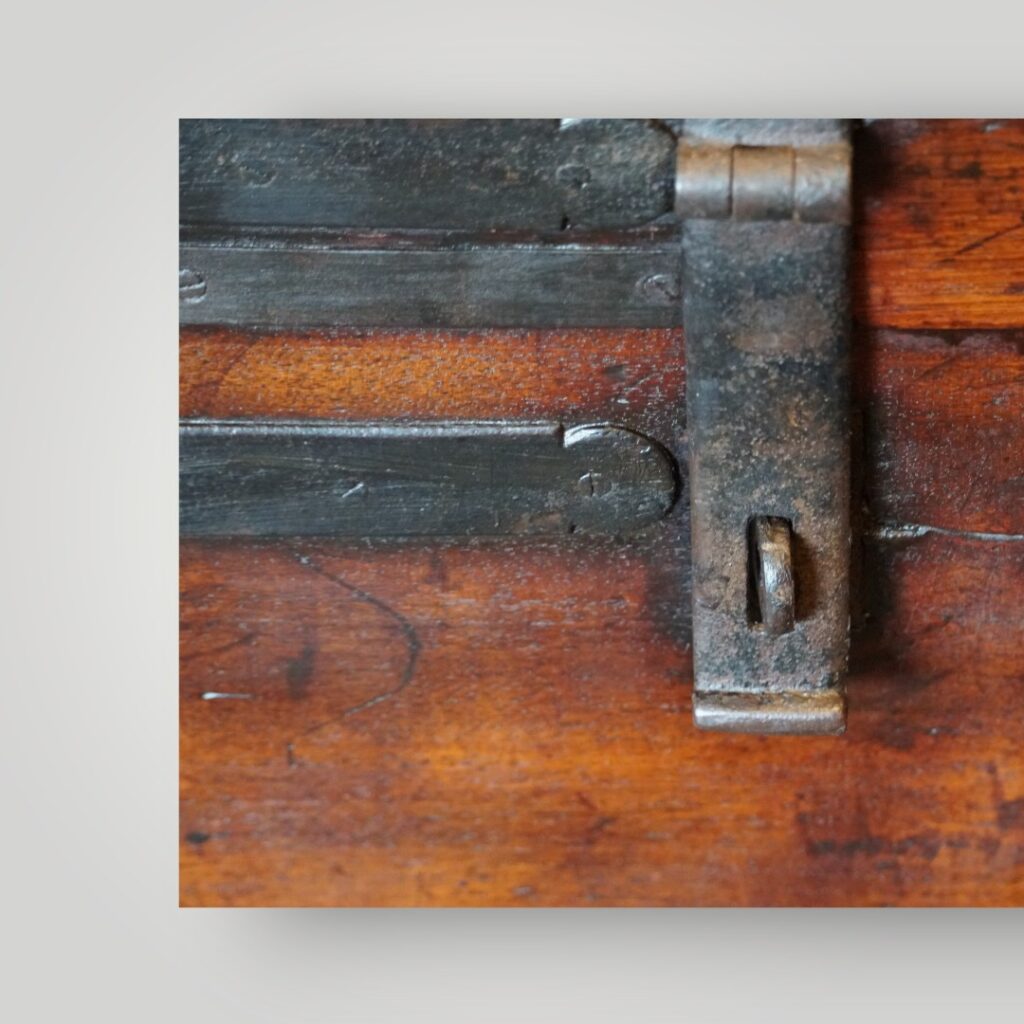 Close‑up of iron strapping on antique trunk