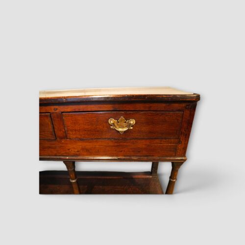 Close‑up of brass handles on antique oak dresser