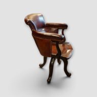Antique mahogany desk chair with leather upholstery