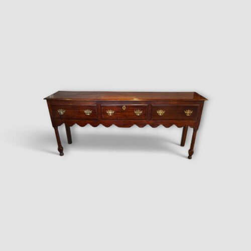 George III oak long dresser base with three drawers